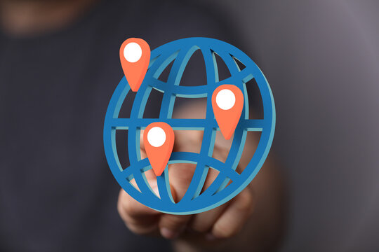 Hand interacts with digital globe, showcasing global reach and connectivity.
