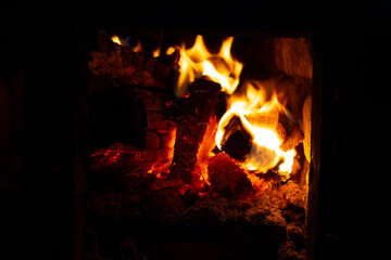 Bright flames dance among the burning logs in a fireplace, providing warmth and a soothing ambiance...