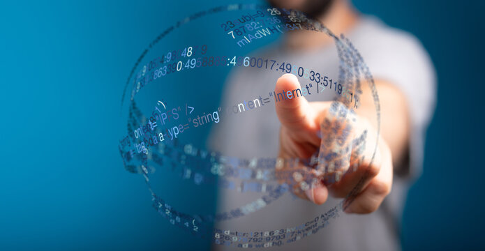A person's finger pointing towards a digital sphere composed of code and data. A concept of technology, innovation, and futuristic in