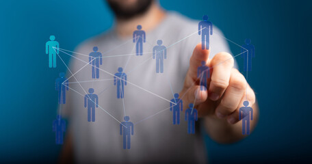 Abstract image of a person touching a network of connected people, representing communication, teamwork, and social connections in a digital wor