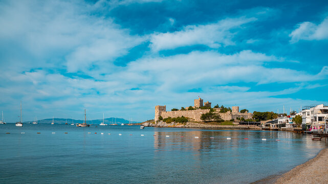 Bodrum Castle and sailboats on a calm blue sea in Bodrum, Turkey