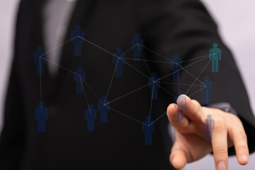 Close-up of a hand pointing to a digital representation of a social network, implying connection and networking