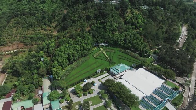 4K Aerial Drone Shot, Our Lady of Ta Pao Statue, Binh Thuan, Vietnam, Mary on Forested Mountain.
Virgin Mary statue, a significant Catholic pilgrimage site, surrounded by nature. 