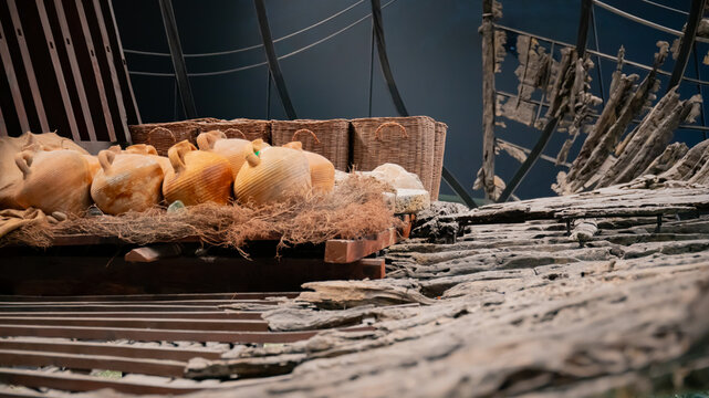 Ancient amphorae and wooden ship remains displayed in a museum. Bodrum Castle Museum, Turkey, 19 May 2025