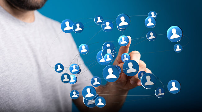 Hand reaching toward connected user icons, representing digital network and teamwork, business, communication, and collaboration.