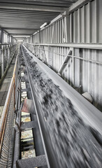 Fototapeta premium Belt conveyor transporting coal in a heating plant, selective focus.