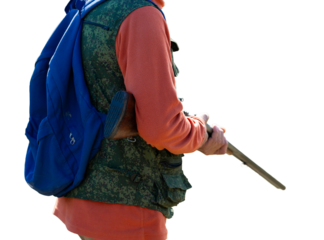 A hunter with a gun in camouflage clothing. A gentleman with a gun, medium shot, unrecognizable.