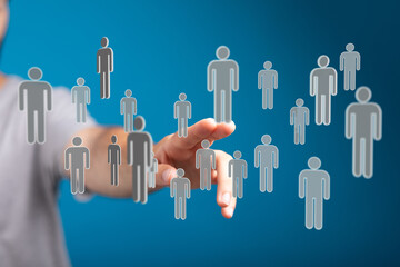 Hand reaching out to interact with digitally rendered people, teamwork and connection concept