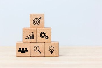Six wooden cubes  showing business icons Concept of business process, analysis, finance, and goal achievement