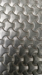 Metal or industrial material texture with a prominent repeating hexagonal pattern, giving an abstract look.
