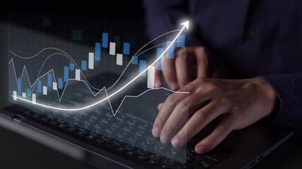 A close-up view of hands typing on a laptop keyboard, featuring an overlay of financial data graphs and an upward arrow, representing business growth and analysis. Copula - Powered by Adobe