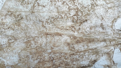 Texture of very dry and cracked mud or soil with a light brown color.
