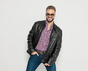 Happy smiling man posing with hand in pocket