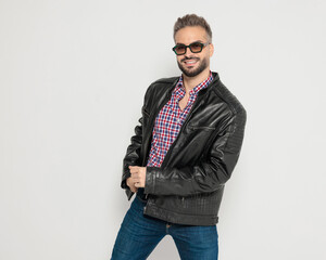 Happy man posing and holding his leather jacket