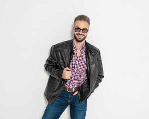 Happy casual man smiling and holding jacket