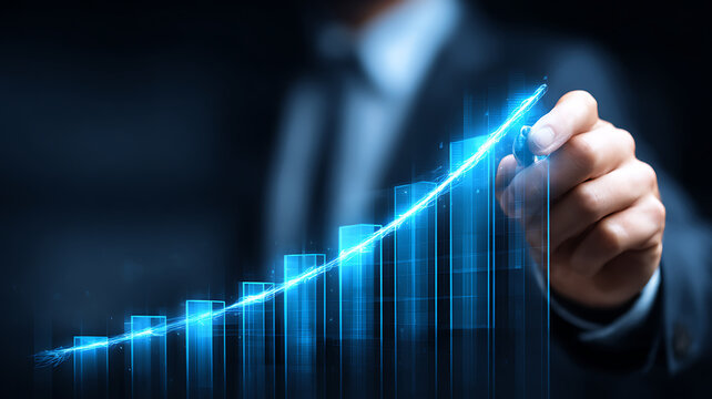 Man draws luminous bar chart on dark background, signifying business progress