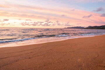 Beautiful orange sunset colors in the sky on the  tropical sandy beach