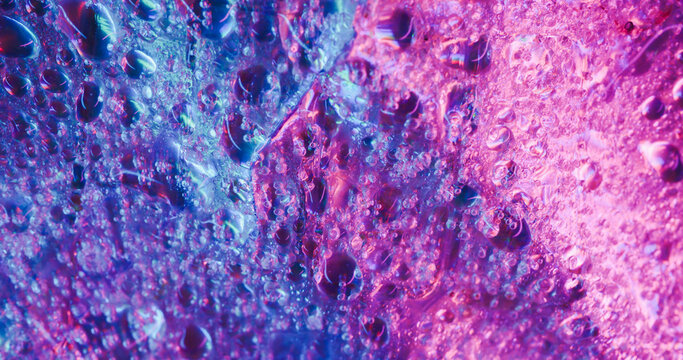 Droplet art. Liquid light. Defocused blue pink neon colorful water texture fluorescent flow pouring on abstract creative background. - Powered by Adobe