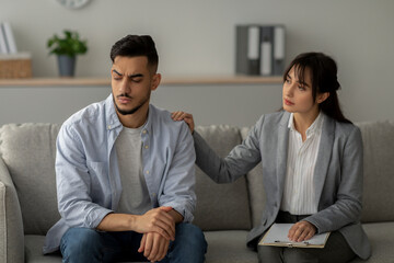 A depressed Arab man is experiencing post-traumatic stress disorder while consulting with a...