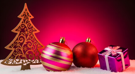 Pink & Gold Christmas Ornaments with Wooden Tree Cutout & Gift Box on Snow – Red Gradient Background for Holiday Cards, Banners, Social Media & Festive Seasonal Marketing