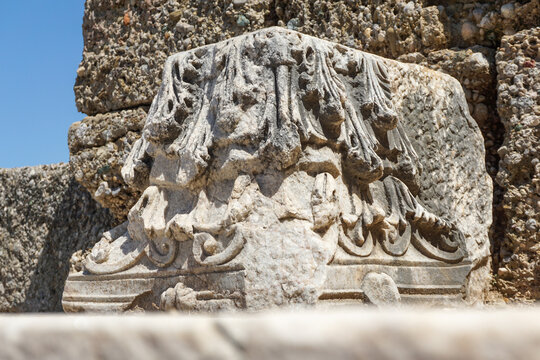 A piece of ancient stone with ancient carvings from the ancient times in the city of Side, Turkey The photo was taken close-up.