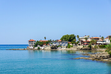 Fototapeta premium A calm blue sea with a few boats floating on it Side Antik Liman