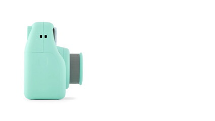 Closeup of turquoise instant photographic camera, isolated on white copy-space background.