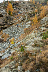 Hiker Climbs Down Large Scree Pile In The Swiss Alps