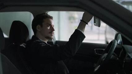 Car buyers exploring vehicles with sales agent assistance at dealership