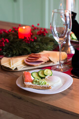 Festive table decor. Christmas feast. Candles, glasses, snacks
