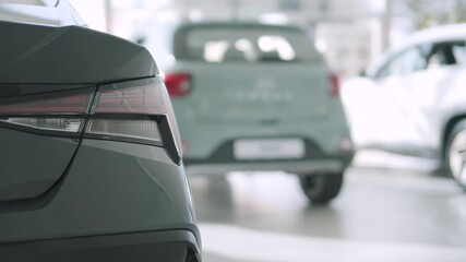 Car buyers exploring vehicles with sales agent assistance at dealership