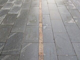 Fototapeta premium Urban pavement with central decorative stone line 