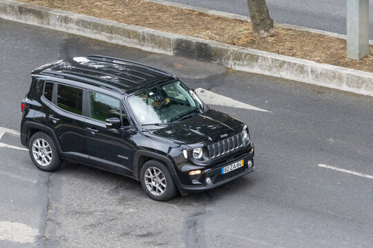 Black jeep renegade suv driving on asphalt road