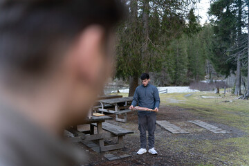 Young man preparing salmon for outdoor cooking