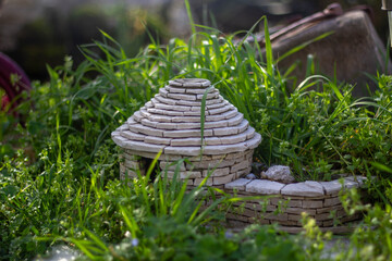 Garden decoration. A model of a classic Istrian stone house ''Kažun'' in a garden