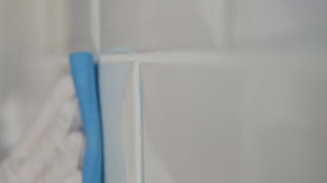Man Wearing Gloves in Hands Cleans Bathroom Faience. Household Chores, Cleaning and Sanitizing the Faience in the Kitchen. 