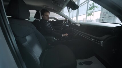 Car buyers exploring vehicles with sales agent assistance at dealership