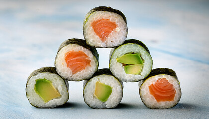 A Stack Of Sushi Rolls With Avocado Cucumber And Salmon