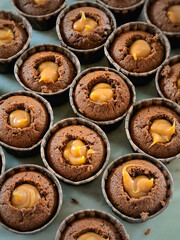 Close-up of freshly homemade baked chocolate cupcakes filled with creamy caramel. 
