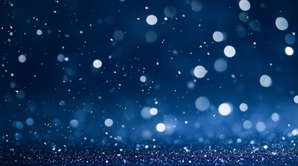 Blue Christmas background with falling glitter and bokeh. Festive winter holiday or New Year's Eve celebration backdrop