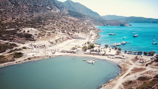 Aerial drone view of Knidos ancient city ruins, peninsula coastline, turquoise Aegean Sea, dramatic landscape, bright Mediterranean light.