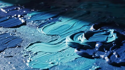 Abstract blue and black paintings, accompanied by a cake with vibrant icing, offer a serene conceptual backdrop for exploring themes of calmness and artistic expression, perfect for designers.