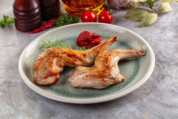 Roasted rabbit leg served rosemary