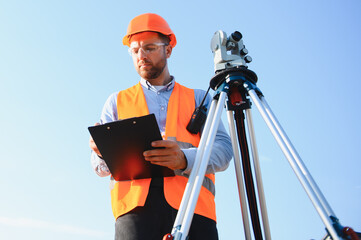 Surveyor man marking land with theodolite equipment