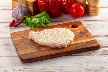 Raw breaded schnitzel for roast