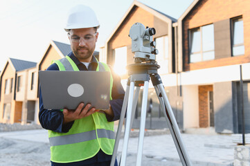 Surveyor geodetic measurement team working at new construction site
