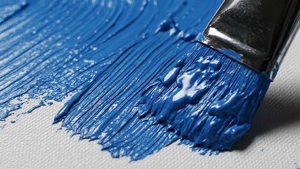 Blue paint brush with white background and handle standing out against pure white surface, perfectly embodying creative freedom and evoking feelings of artistic expression and limitless.