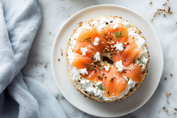 Toasted bagel topped with cream cheese, smoked salmon slices, and herbs on a light plate, photographed in soft natural lighting for fresh food and brunch visuals.