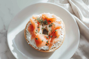 Bagel with smooth cream cheese, layered smoked salmon, and dill garnish presented on a white plate in soft daylight for clean, modern breakfast photography.