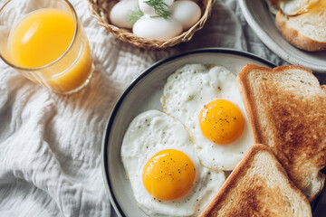 Fried eggs with golden yolks served alongside toast and orange juice, styled with whole eggs and woven basket details for warm breakfast imagery.